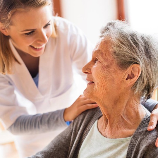 Medical professional with elderly woman